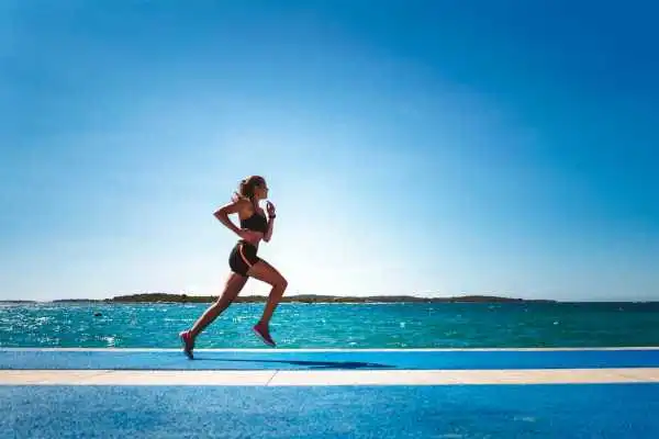 Woman running showing strong leg muscle Pollokshields